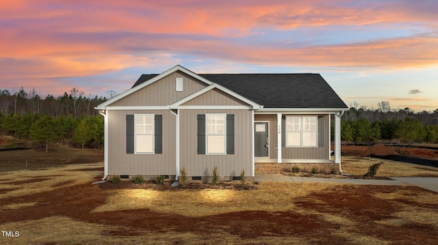 view of front facade with covered porch, a shingled roof, and crawl space