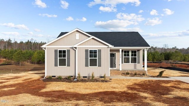 view of front of house with crawl space, covered porch, and a shingled roof