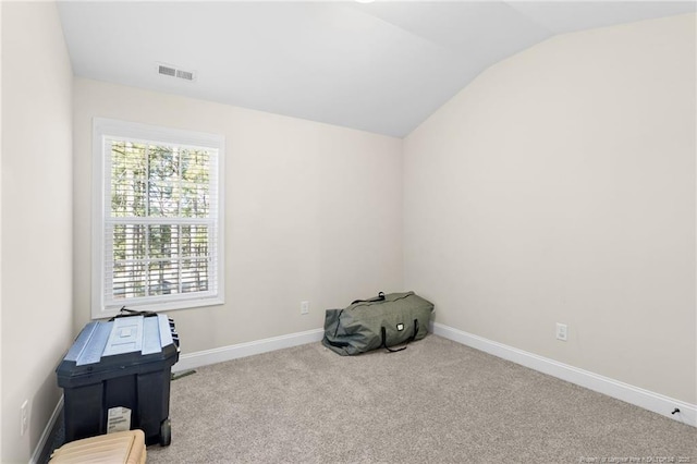 miscellaneous room with vaulted ceiling and light colored carpet