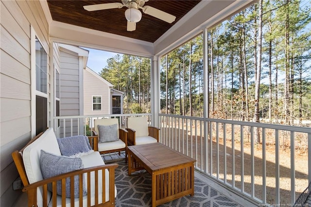 sunroom / solarium featuring wooden ceiling and ceiling fan