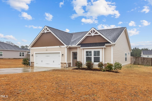 craftsman house featuring roof with shingles, concrete driveway, an attached garage, board and batten siding, and fence