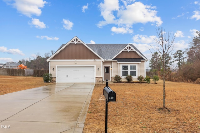 craftsman-style house featuring concrete driveway, a shingled roof, an attached garage, and fence