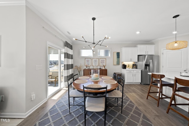 dining area featuring ornamental molding, dark hardwood / wood-style floors, and a chandelier