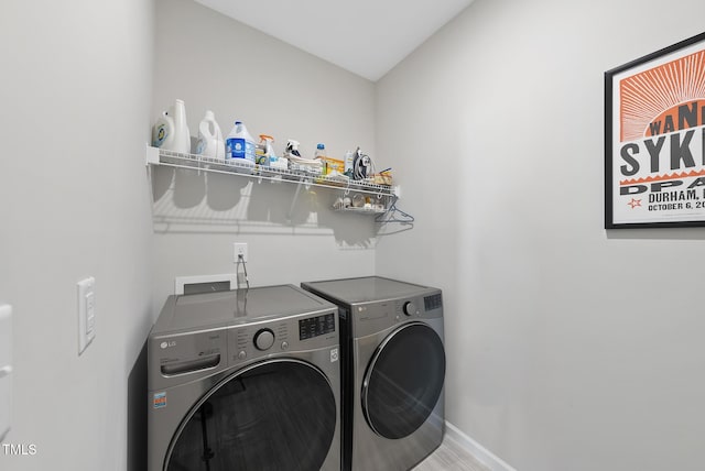 laundry room with washing machine and clothes dryer