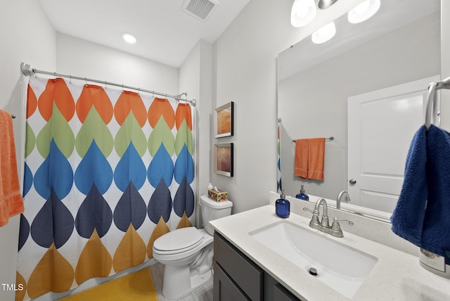 bathroom with vanity, toilet, and curtained shower