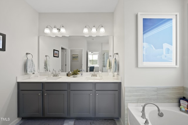 bathroom with vanity and a bath