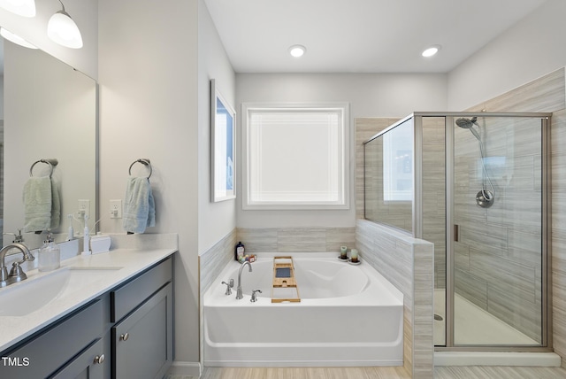 bathroom featuring vanity and separate shower and tub