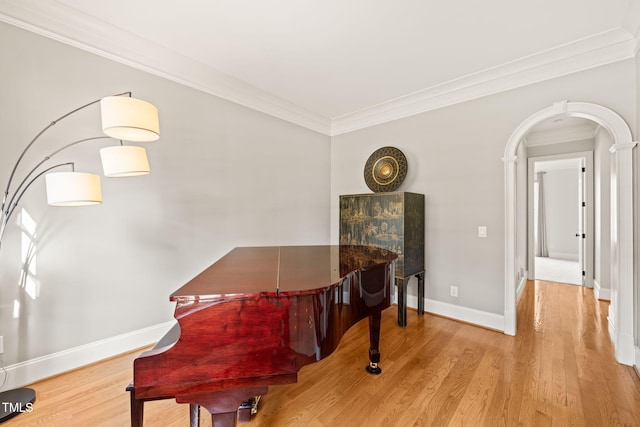 dining space with ornamental molding and light wood-type flooring