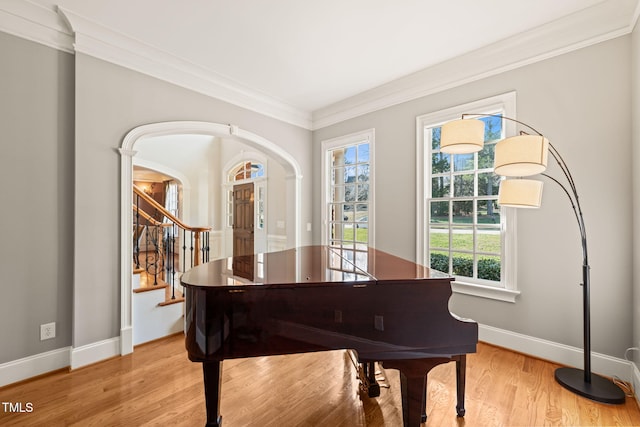 misc room with ornamental molding and light hardwood / wood-style flooring