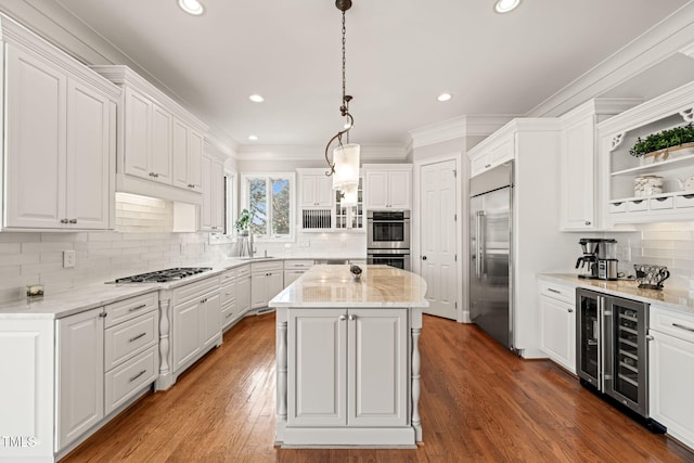 kitchen with white cabinetry, stainless steel appliances, beverage cooler, and a kitchen island