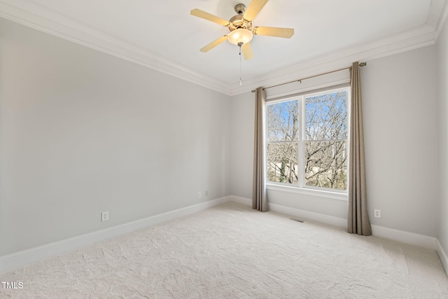 unfurnished room featuring ceiling fan, light colored carpet, and ornamental molding