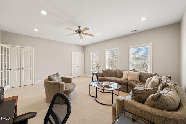 living room featuring light carpet and ceiling fan