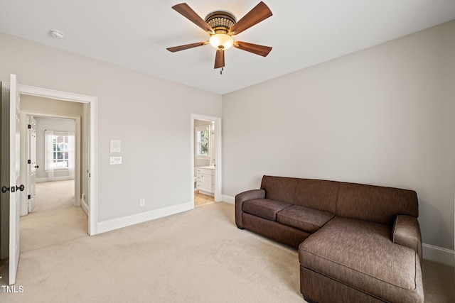 carpeted living room featuring ceiling fan