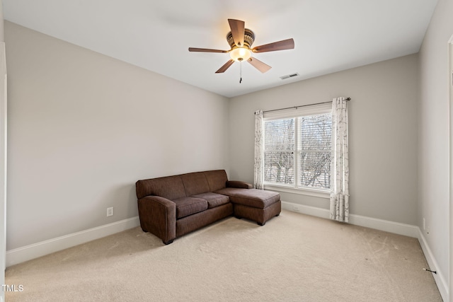 living room with light colored carpet and ceiling fan