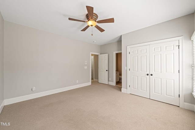 unfurnished bedroom featuring light carpet, a closet, and ceiling fan