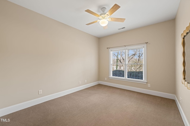 unfurnished room with ceiling fan and carpet