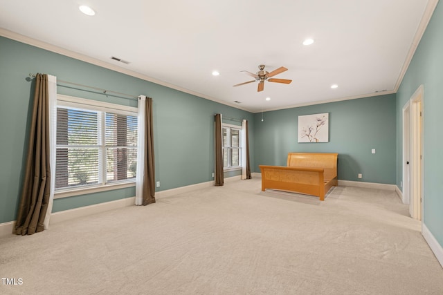 unfurnished bedroom featuring ceiling fan, light colored carpet, and ornamental molding