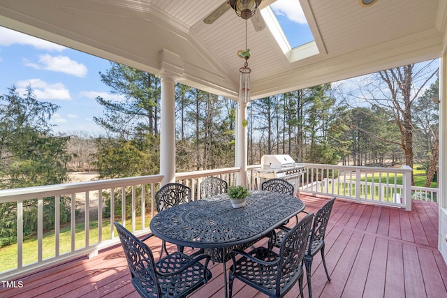 wooden deck with ceiling fan and a grill