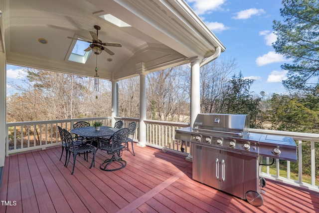 wooden terrace with ceiling fan and area for grilling