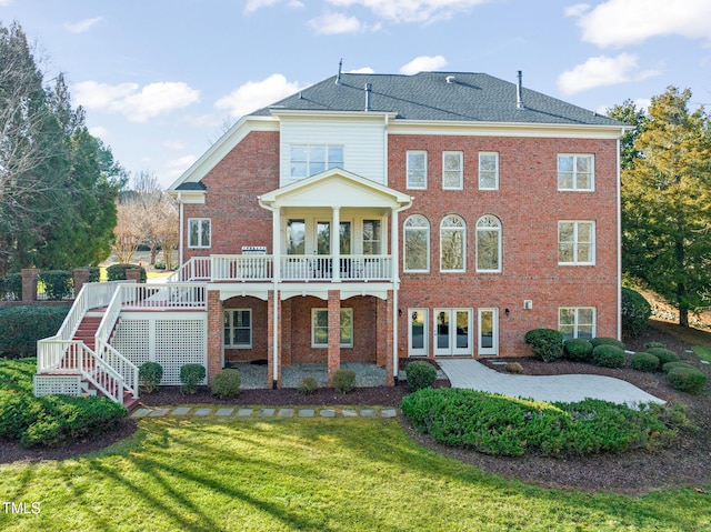 rear view of house featuring a yard, french doors, and a deck