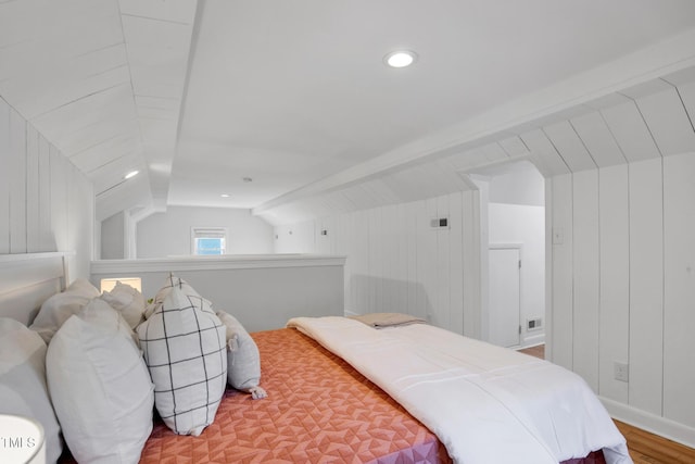 bedroom with hardwood / wood-style flooring and lofted ceiling