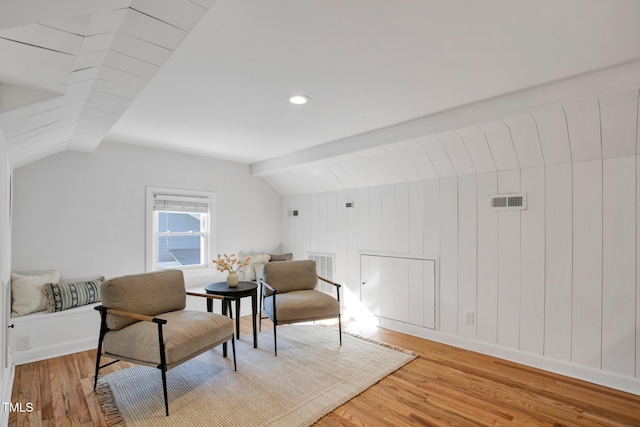 sitting room featuring vaulted ceiling and hardwood / wood-style floors