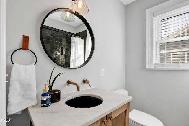 bathroom with vanity, a shower with shower curtain, and toilet