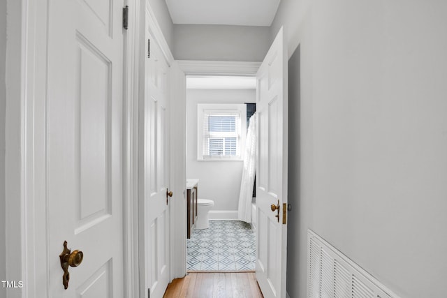 hall with light hardwood / wood-style floors