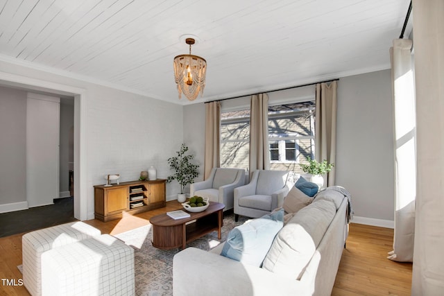 living room with crown molding, wood ceiling, wood-type flooring, and an inviting chandelier