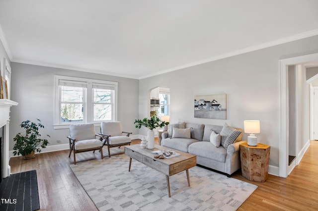 living room with crown molding and light hardwood / wood-style floors