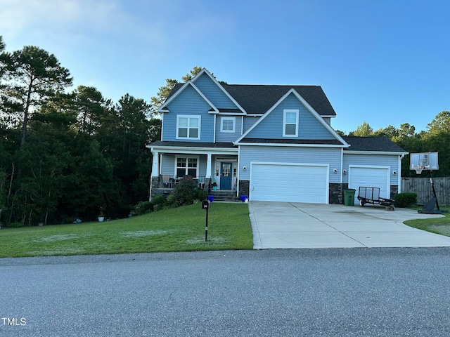 craftsman house featuring a porch, a garage, and a front lawn