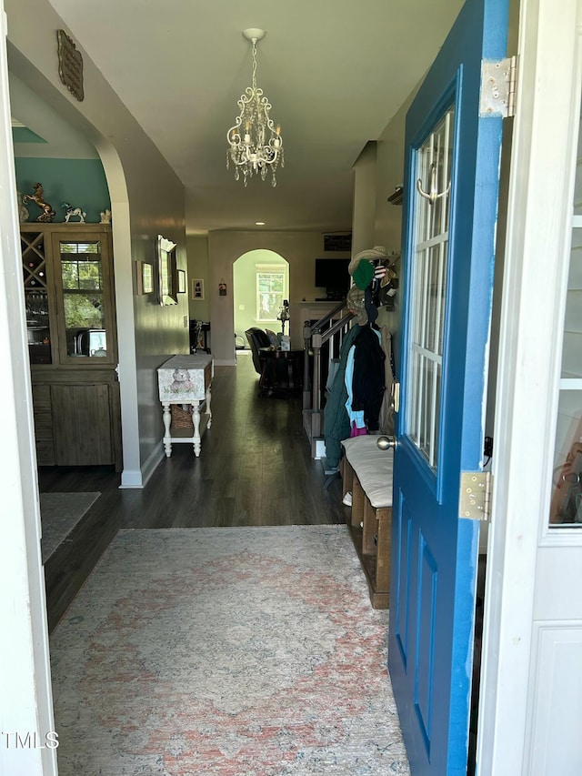 entryway featuring a notable chandelier and dark hardwood / wood-style flooring