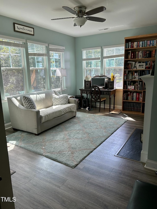 interior space with wood-type flooring and ceiling fan