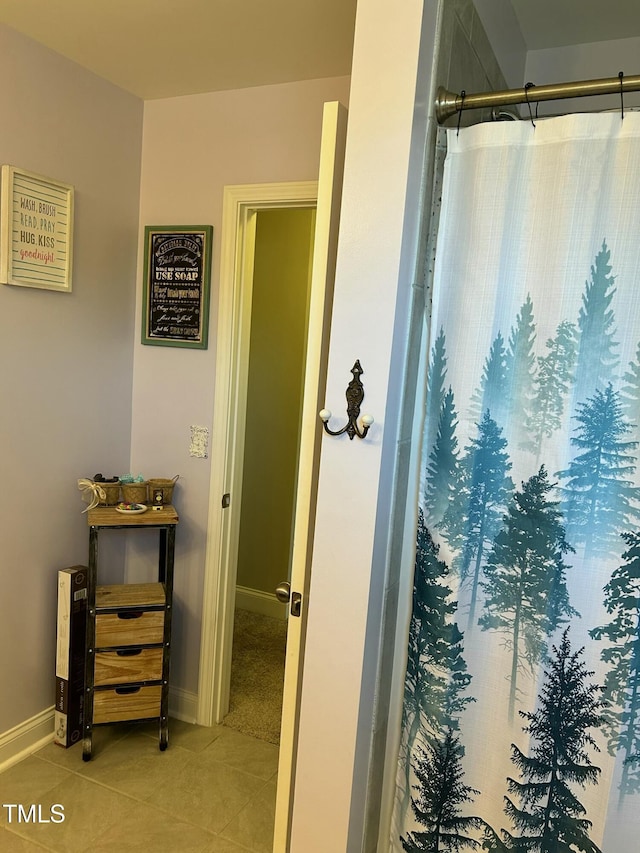 bathroom featuring curtained shower and tile patterned floors