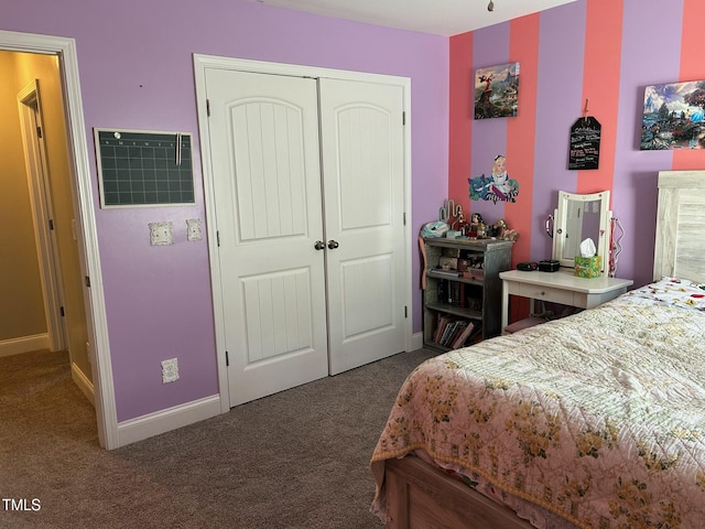 bedroom with a closet and dark colored carpet