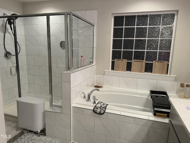 bathroom featuring a shower stall, a bath, and vanity