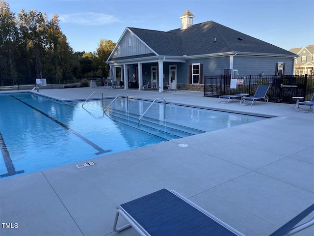 community pool featuring a patio area and fence