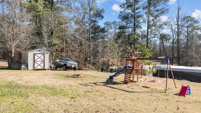 view of jungle gym with a storage shed