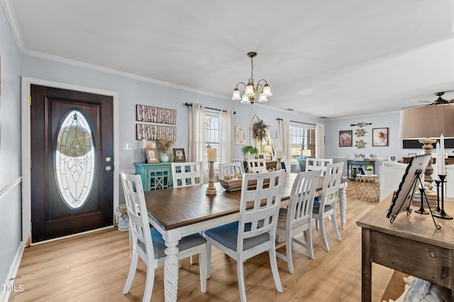 dining space featuring crown molding, ceiling fan with notable chandelier, and light wood-type flooring