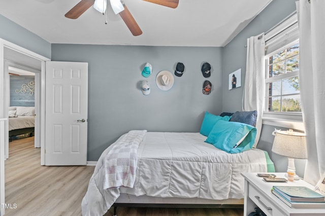 bedroom featuring light hardwood / wood-style flooring and ceiling fan