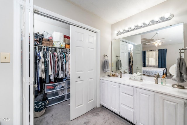 bathroom with ceiling fan and vanity