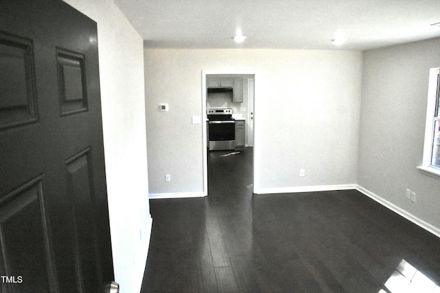 empty room with dark wood-type flooring