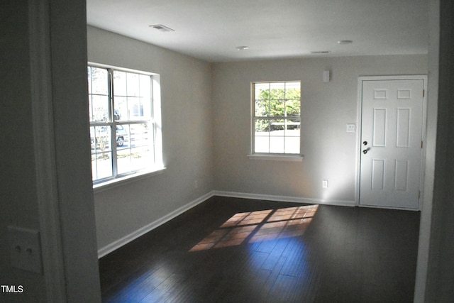 empty room featuring dark wood-type flooring