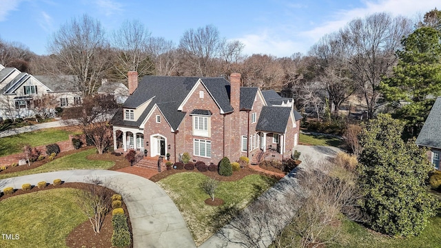 2035 Stuart Ct, Burlington, NC 27215 - view of front of home with a chimney, a front lawn, driveway, brick siding, and roof with shingles