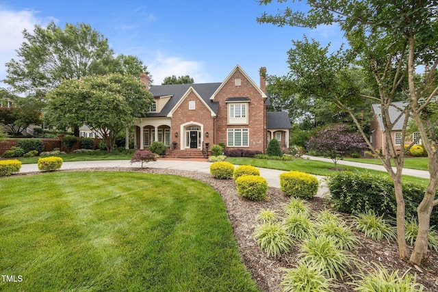 2035 Stuart Ct, Burlington, NC 27215 - view of front facade featuring brick siding, a front yard, and a chimney