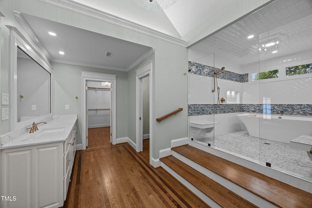 2035 Stuart Ct, Burlington, NC 27215 - bathroom with a walk in shower, vanity, wood finished floors, a spacious closet, and ornamental molding