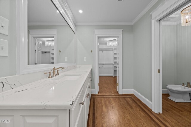 2035 Stuart Ct, Burlington, NC 27215 - bathroom featuring vanity, wood finished floors, a chandelier, a bidet, and crown molding