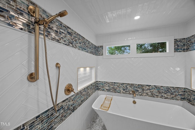 2035 Stuart Ct, Burlington, NC 27215 - full bathroom featuring tile walls, a freestanding tub, and tiled shower