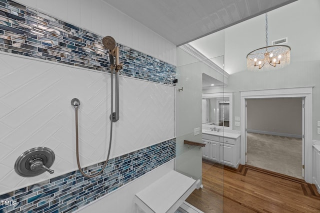 2035 Stuart Ct, Burlington, NC 27215 - bathroom featuring tiled shower, vanity, wood finished floors, and a chandelier