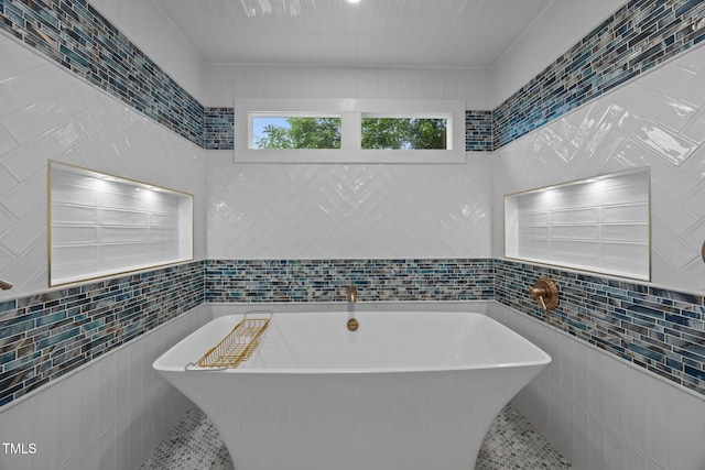 2035 Stuart Ct, Burlington, NC 27215 - bathroom with tile walls, a soaking tub, and tile patterned floors